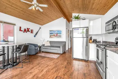 a kitchen and living room with a couch and a table at Beautiful Cabin Right next to Lake Okanagan #5 in West Kelowna