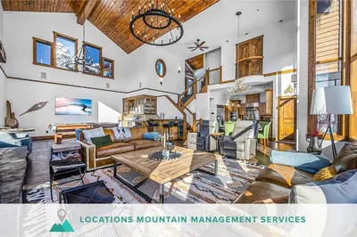 a living room with a couch and a table at Inuksuk Lodge - 4800 sq ft of Big White Excellence! in Big White