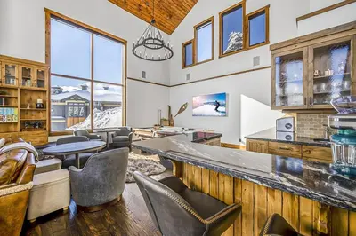 a tasting room with a bar with chairs and tables at Inuksuk Lodge - 4800 sq ft of Big White Excellence! in Big White