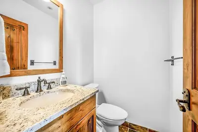 a bathroom with a sink and a toilet at Inuksuk Lodge - 4800 sq ft of Big White Excellence! in Big White