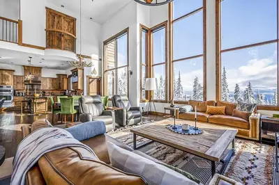a living room with couches and a table at Inuksuk Lodge - 4800 sq ft of Big White Excellence! in Big White