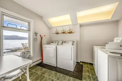 a kitchen with a washer and dryer and a table at The Perfect Getaway Cabin in the Okanagan #6 in West Kelowna