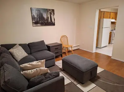 a living room with a couch and a chair at 1-Bedroom Basement Suite in Yellowknife