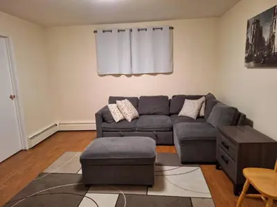 a living room with a couch and a table at 1-Bedroom Basement Suite in Yellowknife