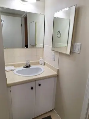 a bathroom with a sink and a mirror at 1-Bedroom Basement Suite in Yellowknife