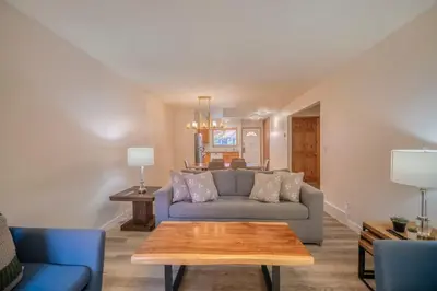 a living room with a couch and a table at Bow Valley Chalets-Entire 2 King Bedrooms townhouse in Canmore
