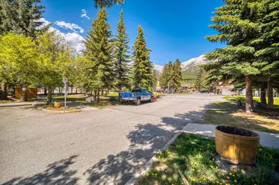 a street with a blue truck parked on the road at Bow Valley Chalets-Entire 2 King Bedrooms townhouse in Canmore