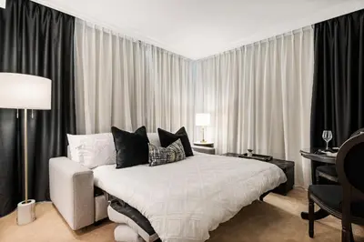 a bedroom with a large bed and a desk with a desk at Elegant & Luxury 2 Bed Suite Close to Convention Centre in Vancouver