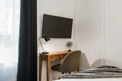 a bedroom with a desk with a television and a chair at Elegant & Luxury 2 Bed Suite Close to Convention Centre in Vancouver
