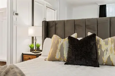 a bedroom with a large bed with pillows at Elegant & Luxury 2 Bed Suite Close to Convention Centre in Vancouver