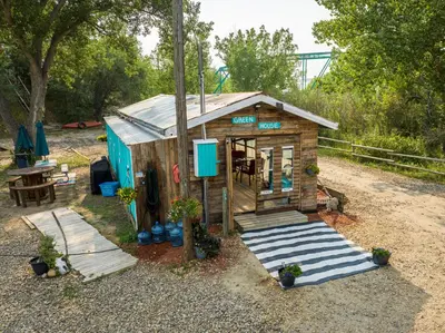 a small shed with a table and a bench at #Y2 Sage & Wildflower Yurt in Drumheller