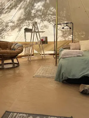 a room with a tent with a bed and a chair at #Y2 Sage & Wildflower Yurt in Drumheller