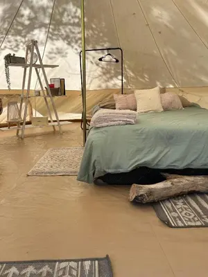 a bedroom with a bed in a tent at #Y3 Willow Tree Yurt in Drumheller