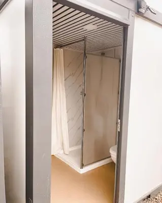 a glass door leading into a bathroom with a shower at #Y4 Aurora Haven Yurt in Drumheller