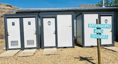 a building with four doors and a sign in front at #Y4 Aurora Haven Yurt in Drumheller