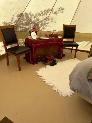 two chairs and a table in a tent at #Y5 Lumberjack Lounge Yurt in Drumheller
