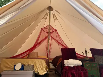 a tent with two chairs and a bed in it at #Y7 Whole New World Yurt in Drumheller