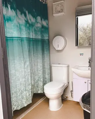 a bathroom with a toilet and a sink at #Y7 Whole New World Yurt in Drumheller