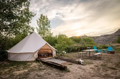 a large white tent with chairs and a table at #Y7 Whole New World Yurt in Drumheller