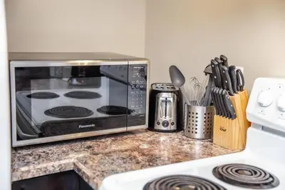a kitchen counter with a microwave on a counter top at Bright Modern Suite - Netflix - WiFi - Long Stays in Edmonton