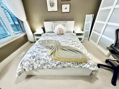 a small bedroom with a bed and a window at Scorpio House Langley -ROOM 1 Separate restroom in Pitt Meadows