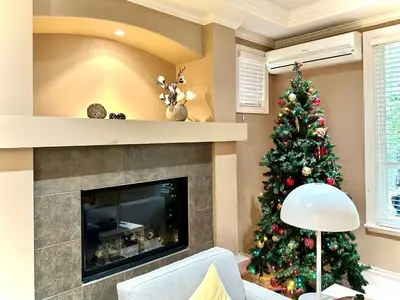 a christmas tree in a living room with a fireplace at Scorpio House Langley -ROOM 1 Separate restroom in Pitt Meadows