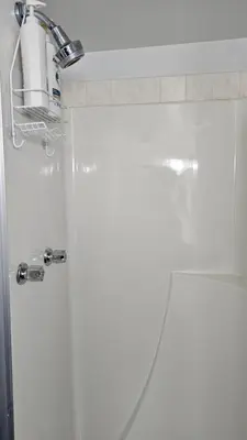 a bathroom with a shower with a shower head at Bright and Cozy Room with Free Parking in Edmonton