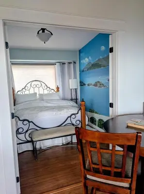 a bedroom with a bed and a table and a chair at Armand Heights in Ganges