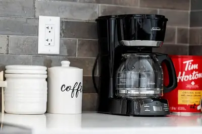a coffee maker sitting on a counter next to a counter top at Stylish Suite-NearWEM-4 Bed-Central in Edmonton