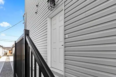 a white door on the side of a house at Stylish Suite-NearWEM-4 Bed-Central in Edmonton