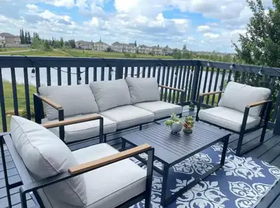 a patio with two couches and a table on a deck at Best home with lake view in Edmonton