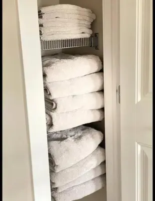 a stack of white towels in a closet at Best home with lake view in Edmonton