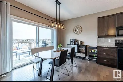 a kitchen with a table and chairs in a room at Best home with lake view in Edmonton