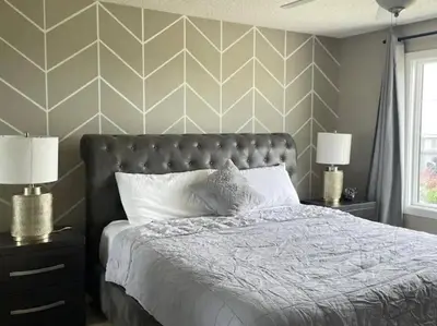 a bedroom with a bed and two night stands with lamps at Best home with lake view in Edmonton