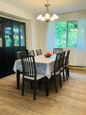 a dining room with a table with chairs and a chandelier at Beautiful home with one acre land for leisure time in Vancouver Island in Nanaimo