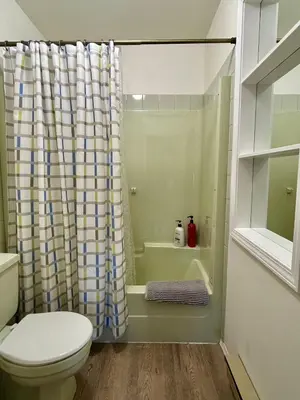 a bathroom with a toilet and a shower curtain at Beautiful home with one acre land for leisure time in Vancouver Island in Nanaimo