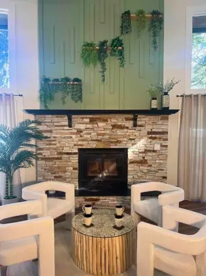 a living room with a fireplace and a table and chairs at Verde Vista - Steam Shower - Theatre - Ping-Pong in Fairmont Hot Springs