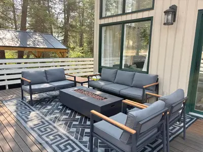 a porch with two couches and a coffee table at Verde Vista - Steam Shower - Theatre - Ping-Pong in Fairmont Hot Springs
