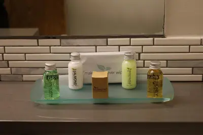a tray with three bottles of moisturizers on a counter at Glacier Mountain Lodge in Blue River