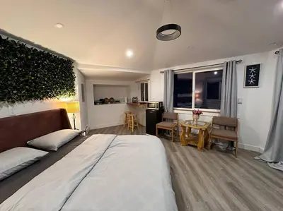 a bedroom with a bed and a living room at Cabin in the woods @ Cultus Lake in Chilliwack
