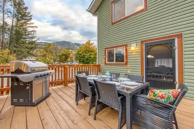 a patio with a table and chairs and a grill at Radium 5BR Home Ping Pong, Foosball, & Gazebo in Radium Hot Springs