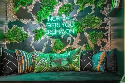 a couch with pillows in front of a wall at Dome House YYC, Iconic, Luxury, Backyard Oasis in Calgary