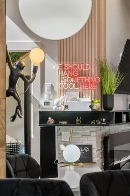 a living room with a fireplace and a statue of a man at Dome House YYC, Iconic, Luxury, Backyard Oasis in Calgary