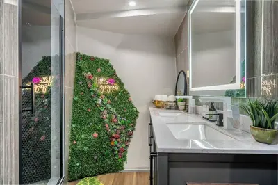 a bathroom with a green wall with a sink at Dome House YYC, Iconic, Luxury, Backyard Oasis in Calgary