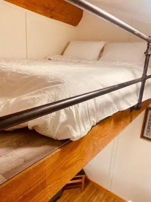 a metal bunk bed in a small room at Ski-In Chalet: Private Hot tub, Bonus Bunk House in Fernie