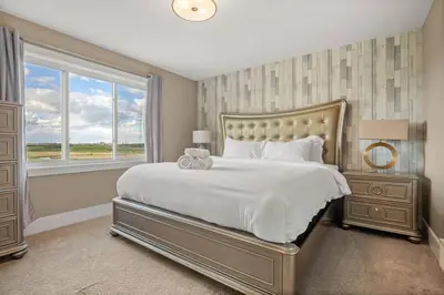 a bedroom with a large bed and a window at Large Detached Near Anthony Henday in Albany with 2 Living Rooms, Netflix, Office Space, AC, Perfect for Families, Sleeps 13 in Edmonton
