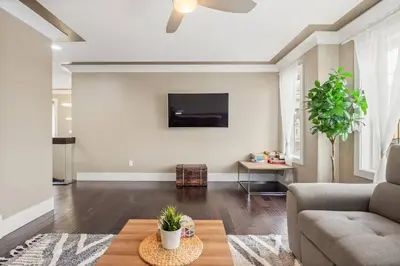 a living room with a couch and a table at Large Detached Near Anthony Henday in Albany with 2 Living Rooms, Netflix, Office Space, AC, Perfect for Families, Sleeps 13 in Edmonton