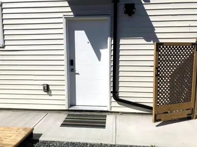 a white door on a house with a porch at Gorgeous 2 Bedrooms Suite Private entrance with patio-Free Parking in Maple Ridge District Municipality