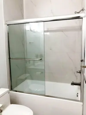 a glass shower in a bathroom with a toilet at Gorgeous 2 Bedrooms Suite Private entrance with patio-Free Parking in Maple Ridge District Municipality