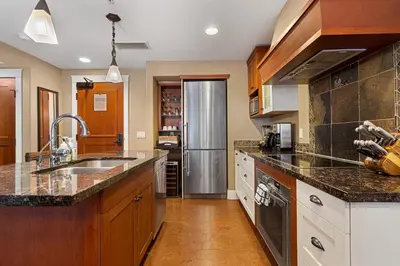 a large kitchen with a stainless steel refrigerator at Luxury Resort 2Bedroom 2Bath Sleeps 6 945 square feet in Canmore